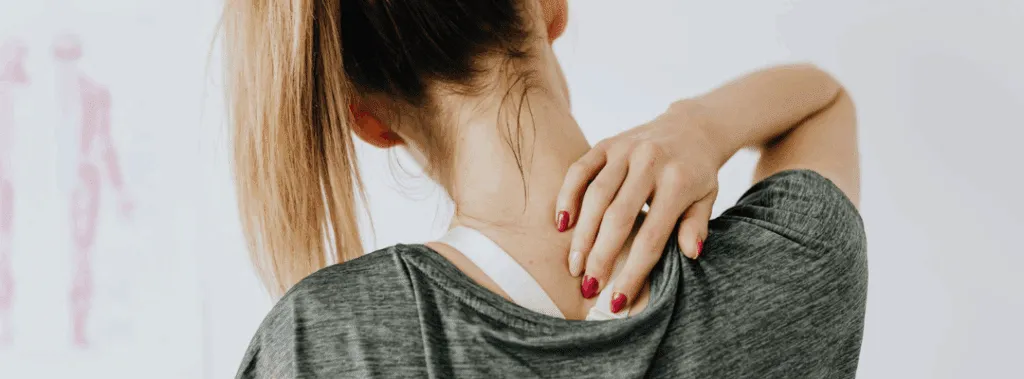 Woman Grabbing Neck and Shoulder in Pain